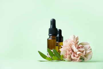 Fototapeta na wymiar Essential oils , various bottles aromatherapy on a green background. Aromatherapy and perfumes concept