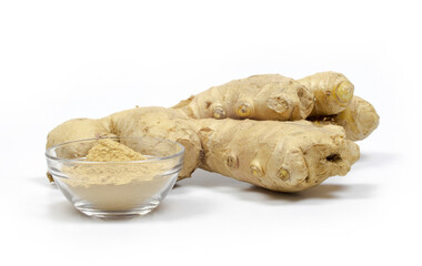 ginger root and powder in a glass bowl isolated on white background