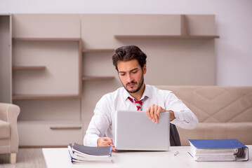 Young male employee working from home during pandemic