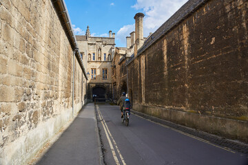 OXFORD, UK - April 13, 2021. A woman with a child on bike cycling in Oxford