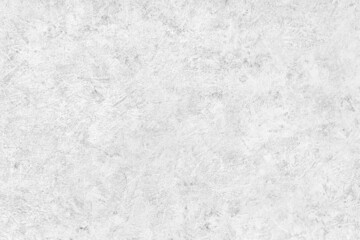Abstract light grey plastered textured grunge background in the form of a rough covered stucco wall, closeup