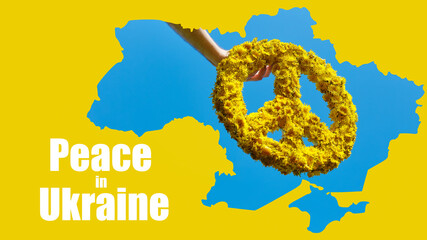 Obraz premium A man's hand holds a crown of yellow dandelions, isolated in the clear bright blue sky. Symbol in Ukraine. Stop war.
