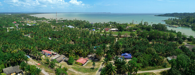 Panoramic aerial drone view of rural settlements near the seaside in Sedili Kecil, Johor, Malaysia