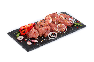 Pieces of meat with marinade on a black board
