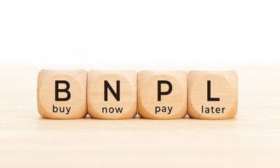 BNPL text in wooden blocks. Buy now pay later concept. Copy space