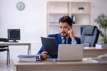 Young male employee working in the office