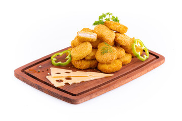 Chicken nuggets with cheese on a wooden board