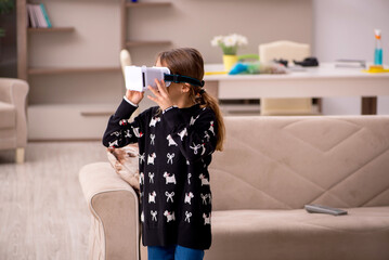 Young little girl enjoying virtual glasses at home