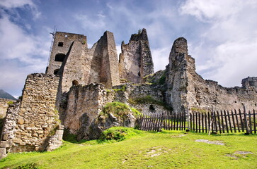 Medieval ruins panorama or castle with beautiful blue sky and green meadow. View of Likava castle...