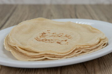 Stack of flour tortillas on a plate ready to make into a delicious Mexican meal