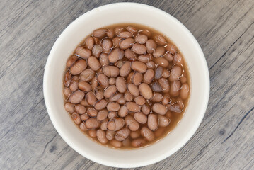Overhead view of hearty bowl of pinto beans to perfectly compliment any Mexican food meal