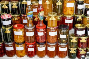 Shop counter with traditional sweets, jams and fruit drinks, mixed in jars