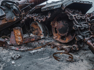 Fototapeta premium War in Ukraine, Zhytomyr highway, Kyiv region, a destroyed Russian tank with a torn off turret stands on the highway.