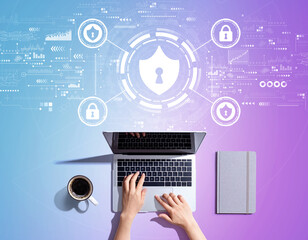 Cyber security theme with person using a laptop computer