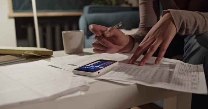 Cropped accountant using calculator app