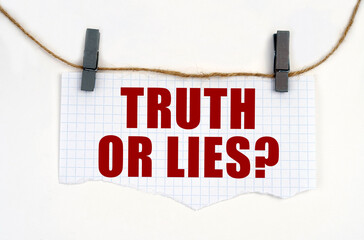 A sheet of paper with the inscription is attached to the rope with clothespins - TRUTH OR LIES