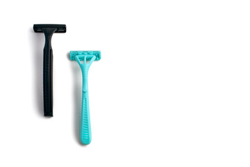 Two plastic razors in black and blue on a white background. Male and female disposable razor with free space for text. The concept of care for appearance and care for smooth skin
