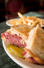 A corned beef reuben with a side of fries