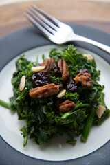 Kale salad with pecans, pumpkin seeds, and dried cranberries.
