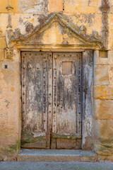 Wooden door on an ancient stone building