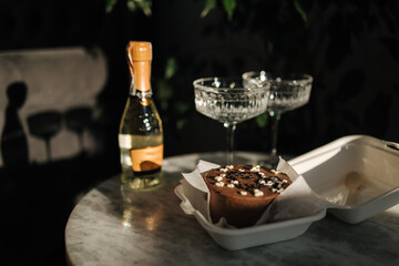Chocolate bento cake with little champagne for a little birthday party. Exquisite champagne glasses...