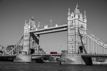 Fototapeta na wymiar Red bus passing Tower bridge, red and grey color