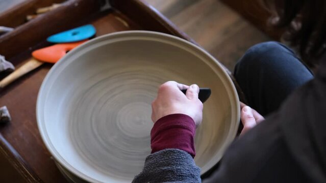 Pottery polishing process with 2 hands in the final step. Before entering the kiln. Slow motion video