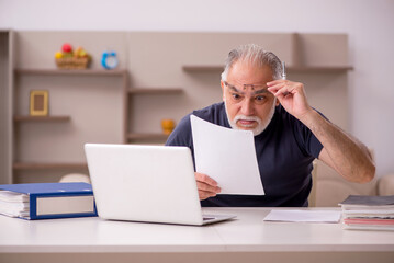 Old male employee working from home during pandemic