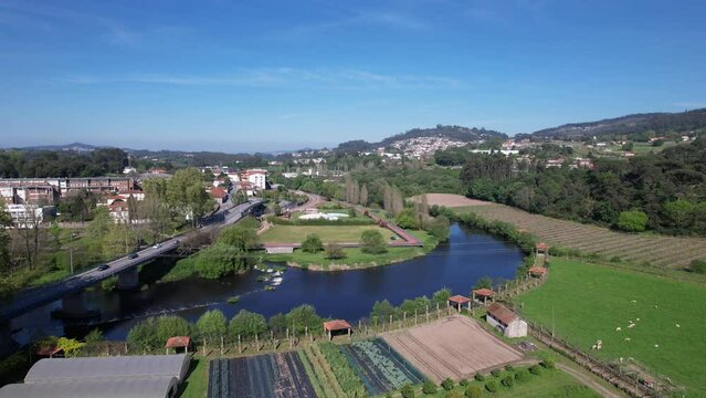 DRONE AERIAL FOOTAGE: Small waterfall on the Ave River in Santo Tirso, Portugal.