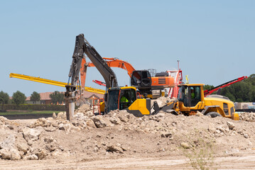 Obraz premium industrial hydraulic excavator on construction and demolition site, recycling construction waste with bulldozer