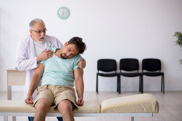 Young male patient visiting old male doctor