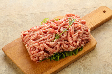 Raw minced pork meat over board