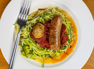 zucchini noodles in pasta sauce and top with meat ball and italian sausage