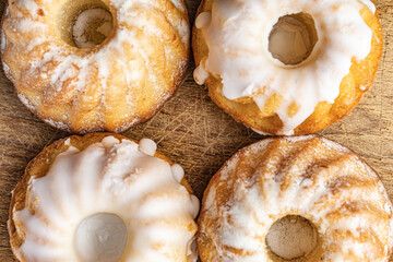 muffins in powdered sugar on a wooden background top view