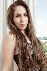 Obraz premium Cute Caucasian girl, blonde hair, wearing lingerie in a hotel room, sensualizing in a photo shoot