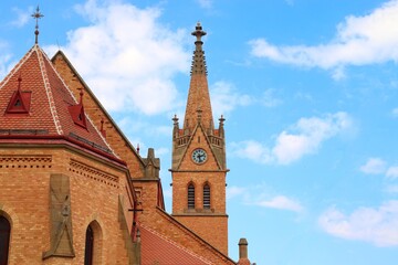 A view to the beautiful church built from little brown bricks and blue sky in background at Uhercice, Czech republic