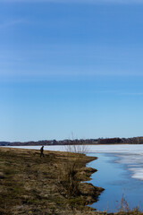 beautiful place, unknown man looking at nothing in a lake