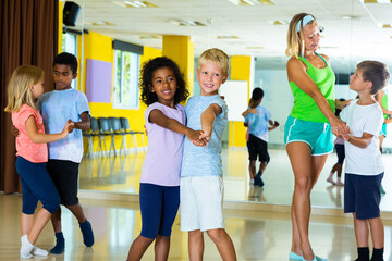 Little boys and girls dancing pair dance in the ballet studio. High quality photo