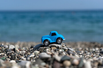 Fototapeta na wymiar A car standing on the stones on the beach