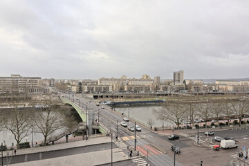Bridge over river Seine in Rouen with office buildings and trees on the quays, Rouen, France  - obrazy, fototapety, plakaty
