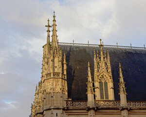 Gothic architecture detail with decorated windows with statues, banners, flowers and pinnacles of...