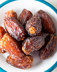 Fresh red dates (hurma) in a bowl