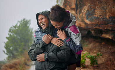No one could ever make me feel the way you do. Shot of a young couple wearing their rain jackets...