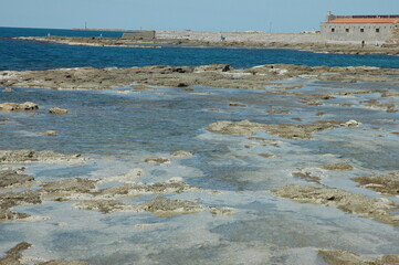 Rocks at low tide on the Livorno seafront. Close to the Port