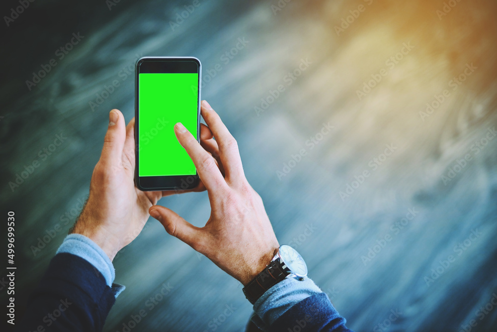 Poster taking a quick look at the market online. shot of an unrecognizable businessman using his cellphone 