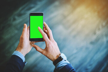Taking a quick look at the market online. Shot of an unrecognizable businessman using his cellphone at work.