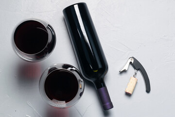 Aerial view of a bottle , glasses and corkscrew.