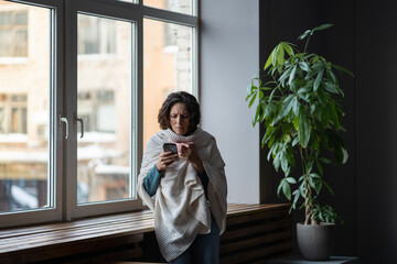 Sick woman having COVID infection symptoms typing message, sms or sick day email to manager,...