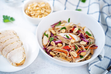 Warm backwheat pasta chicken vegetables salad with peanuts