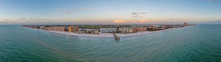 Drone panorama over Redington Beach in St. Petersburg in Florida with pier at sunset